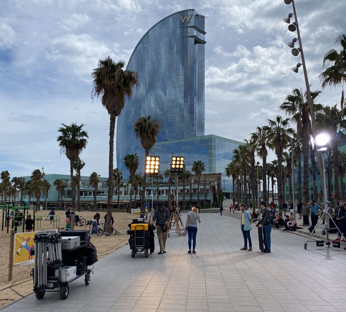 Glassy Films crew, lighting towers and gear on the Barceloneta promenade by the W Hotel