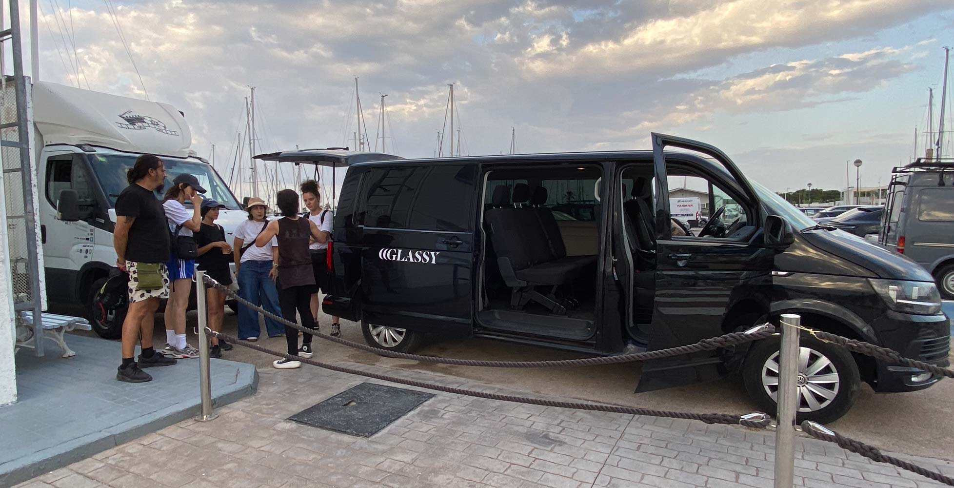 Glassy Films van and crew at a marina, getting ready for a location shoot