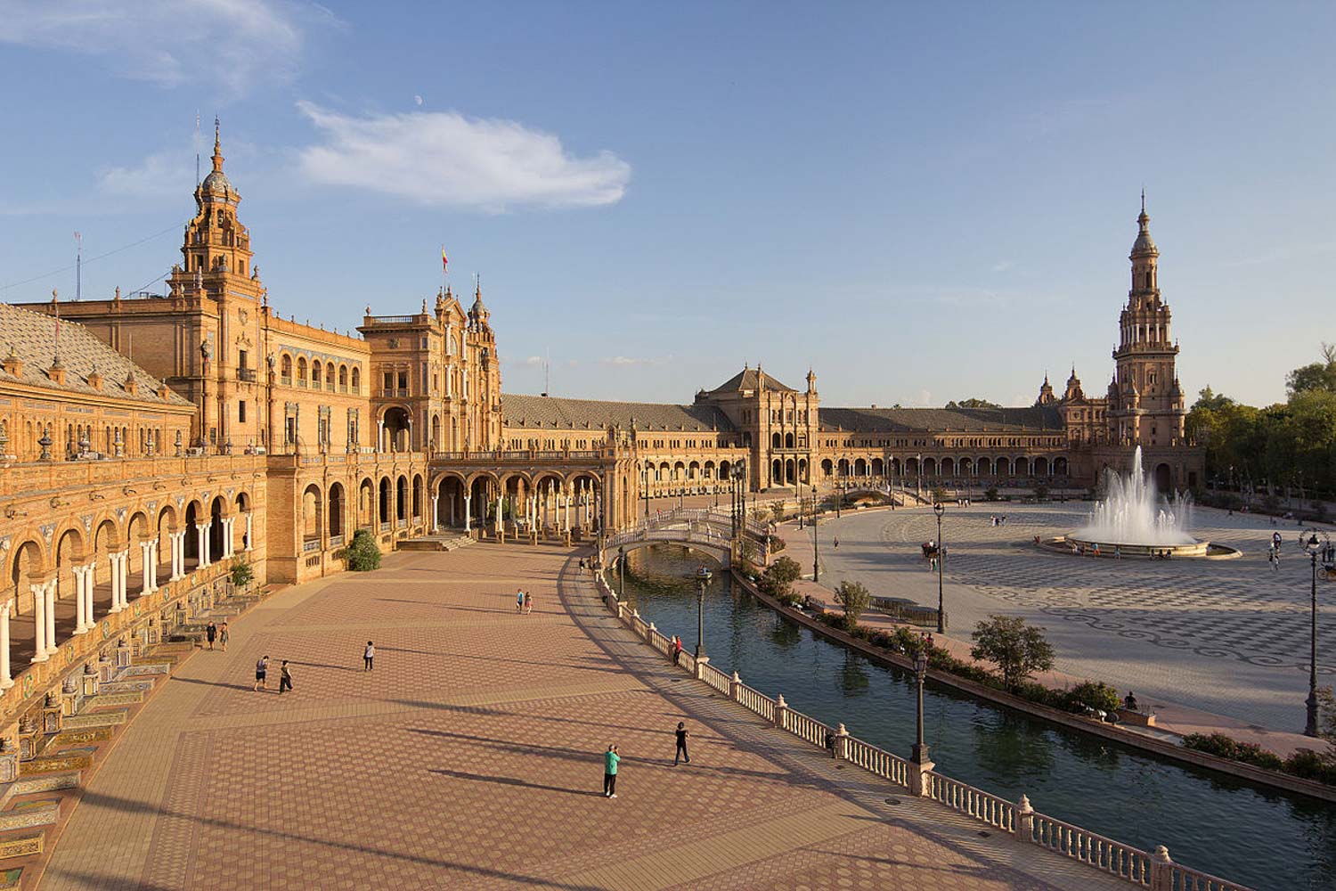 Wide view of Seville's Plaza de España with its canal and fountain